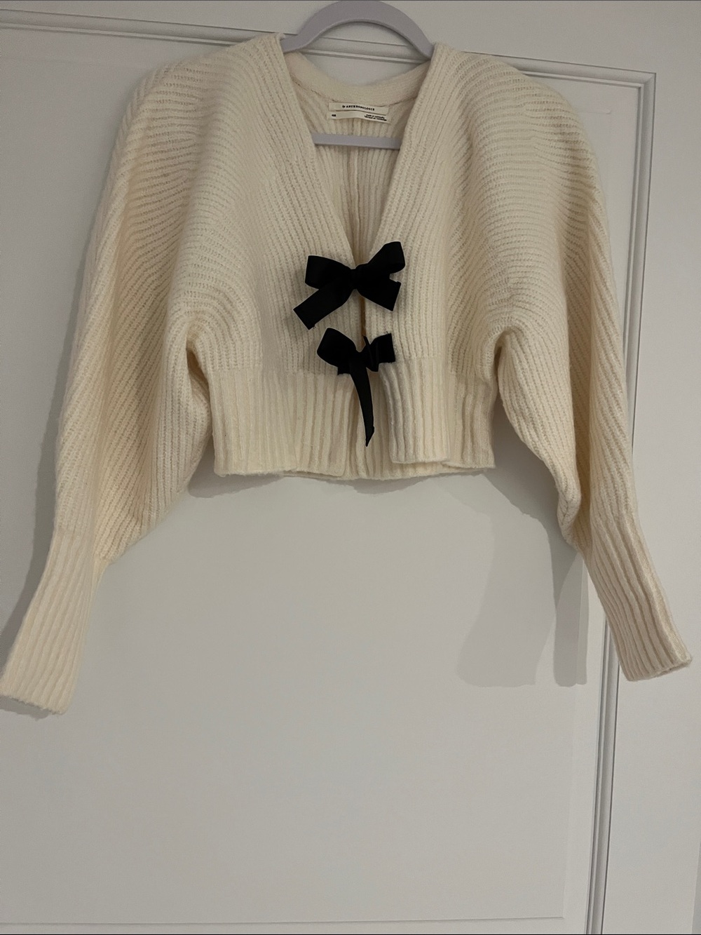 Anthropologie Cream V-Neck Cropped Sweater with Black Bow Accents